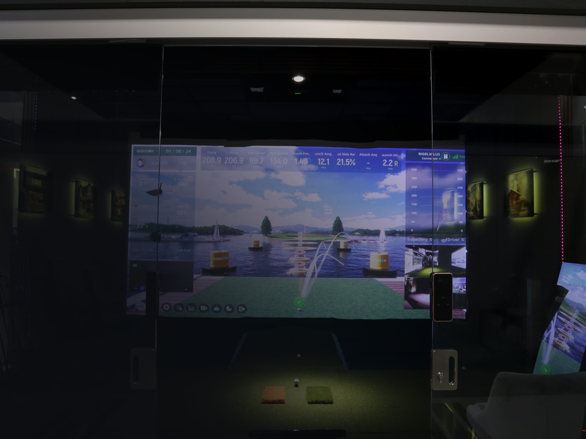 Golf simulator suite with an impact screen and enclosure, installed by AV Guys