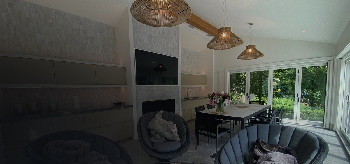 Living room with a wall-mounted TV over the fireplace, installed by AV Guys