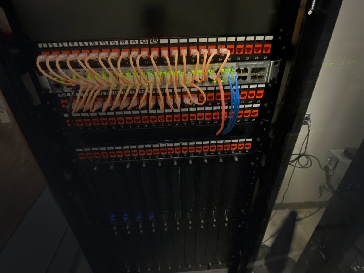 Network rack with patch panels, a managed switch and structured cabling, installed by AV Guys