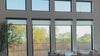 Motorized shades lowering and rising over windows